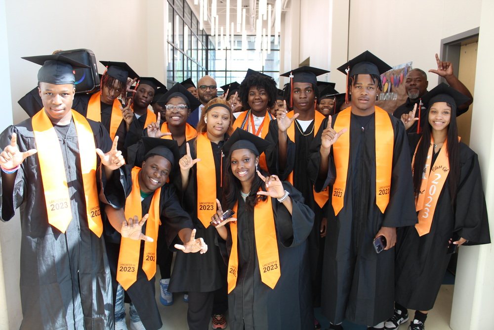 Students pose in graduation regalia