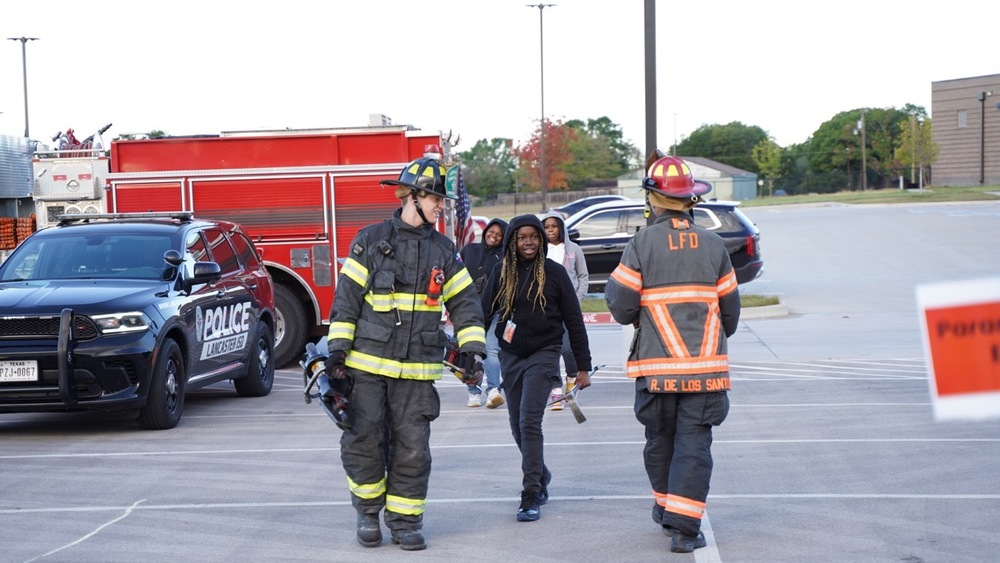Firefighters walking with student